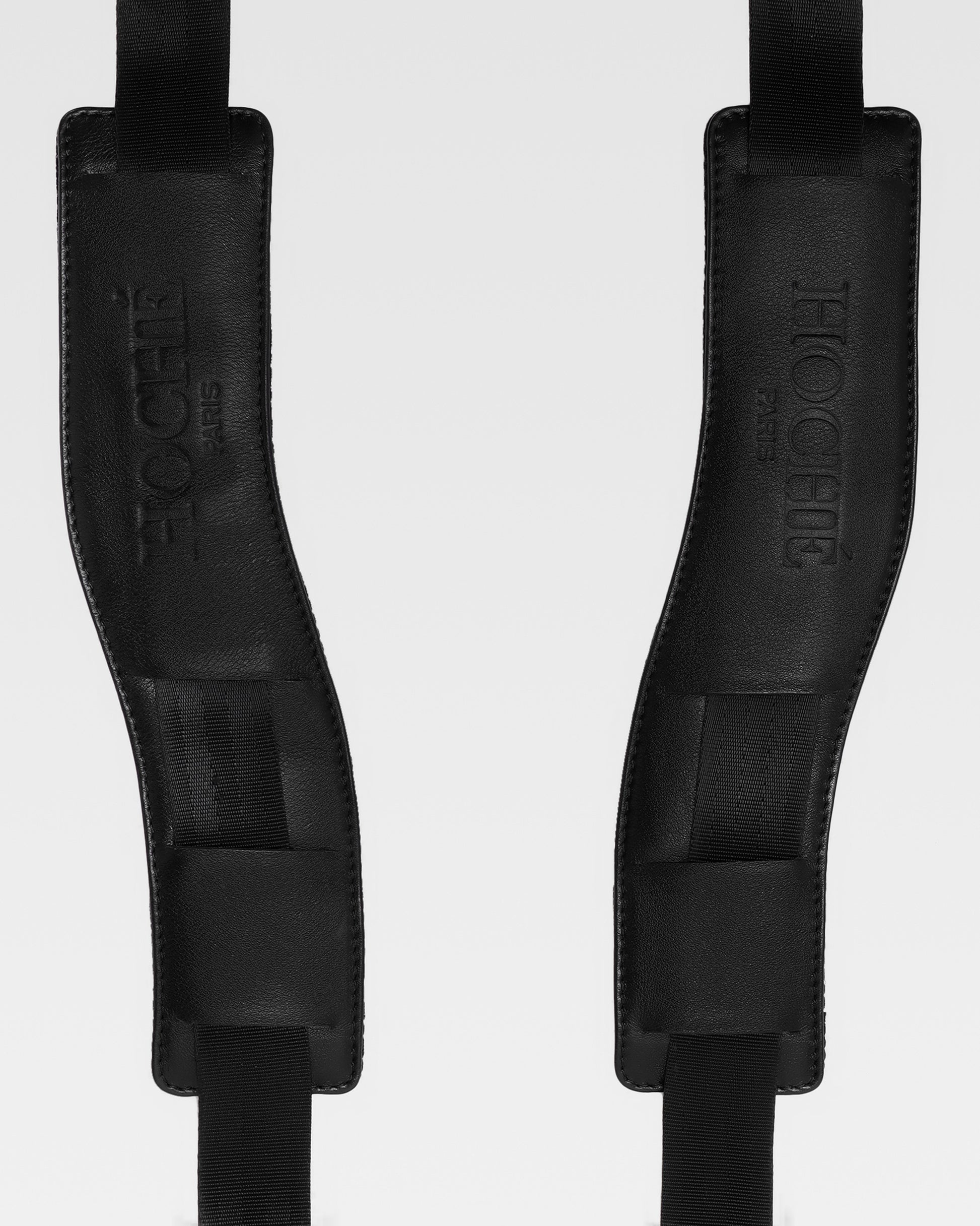 Close-up of UniSwitch black genuine leather backpack for men in India, highlighting premium craftsmanship, and Hoche paris embossed logo