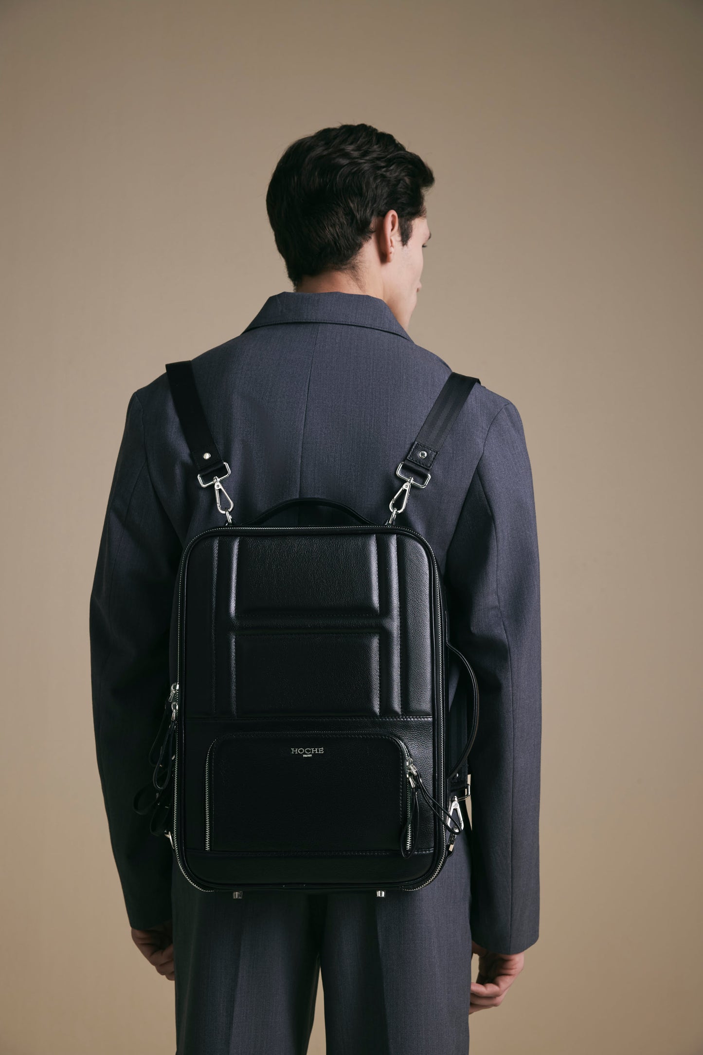 Lifestyle view of UniSwitch black branded genuine leather 3 in 1 convertible  backpack for men in India. Stylish and trendy.