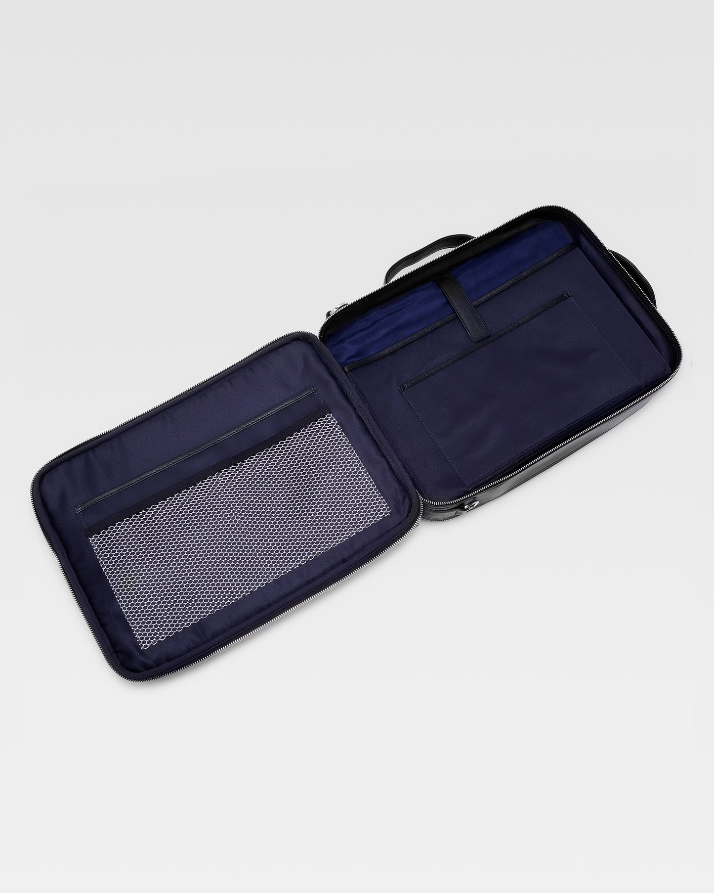 Open view of UniSwitch black branded genuine leather backpack for men in India, showcasing spacious compartments, a padded laptop sleeve, and secure storage