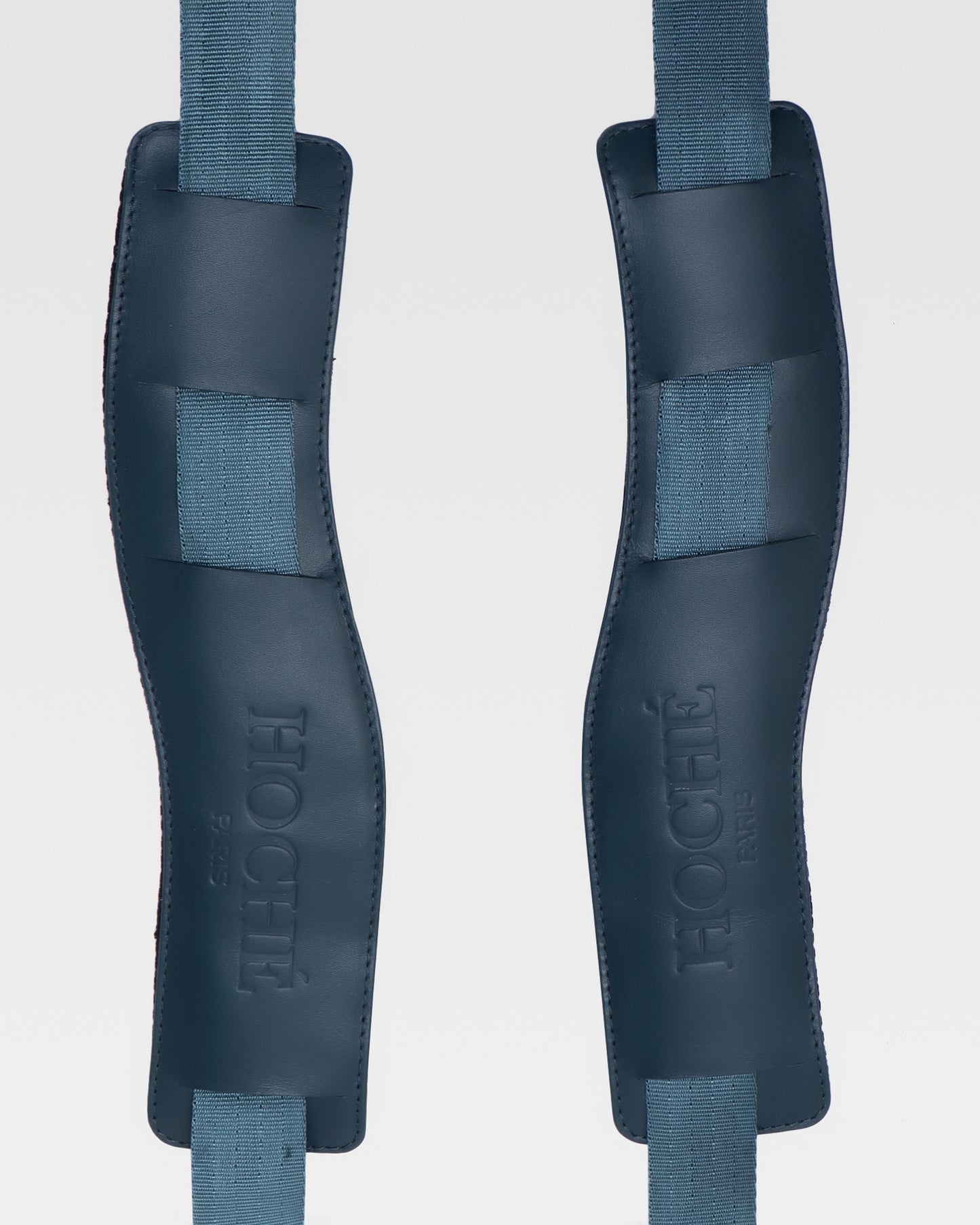 Close-up of UniSwitch dark blue genuine leather backpack for men in India, highlighting premium craftsmanship, and Hoche paris embossed logo