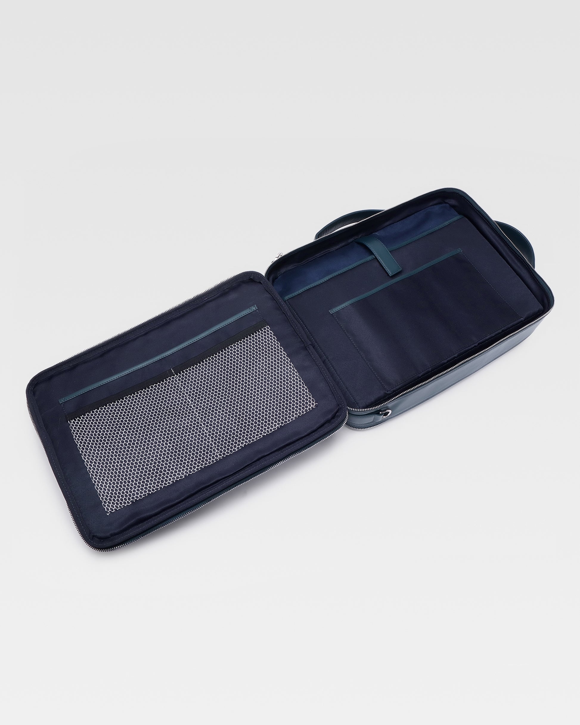 Open view of UniSwitch dark blue branded genuine leather backpack for men in India, showcasing spacious compartments, a padded laptop sleeve, and secure storage