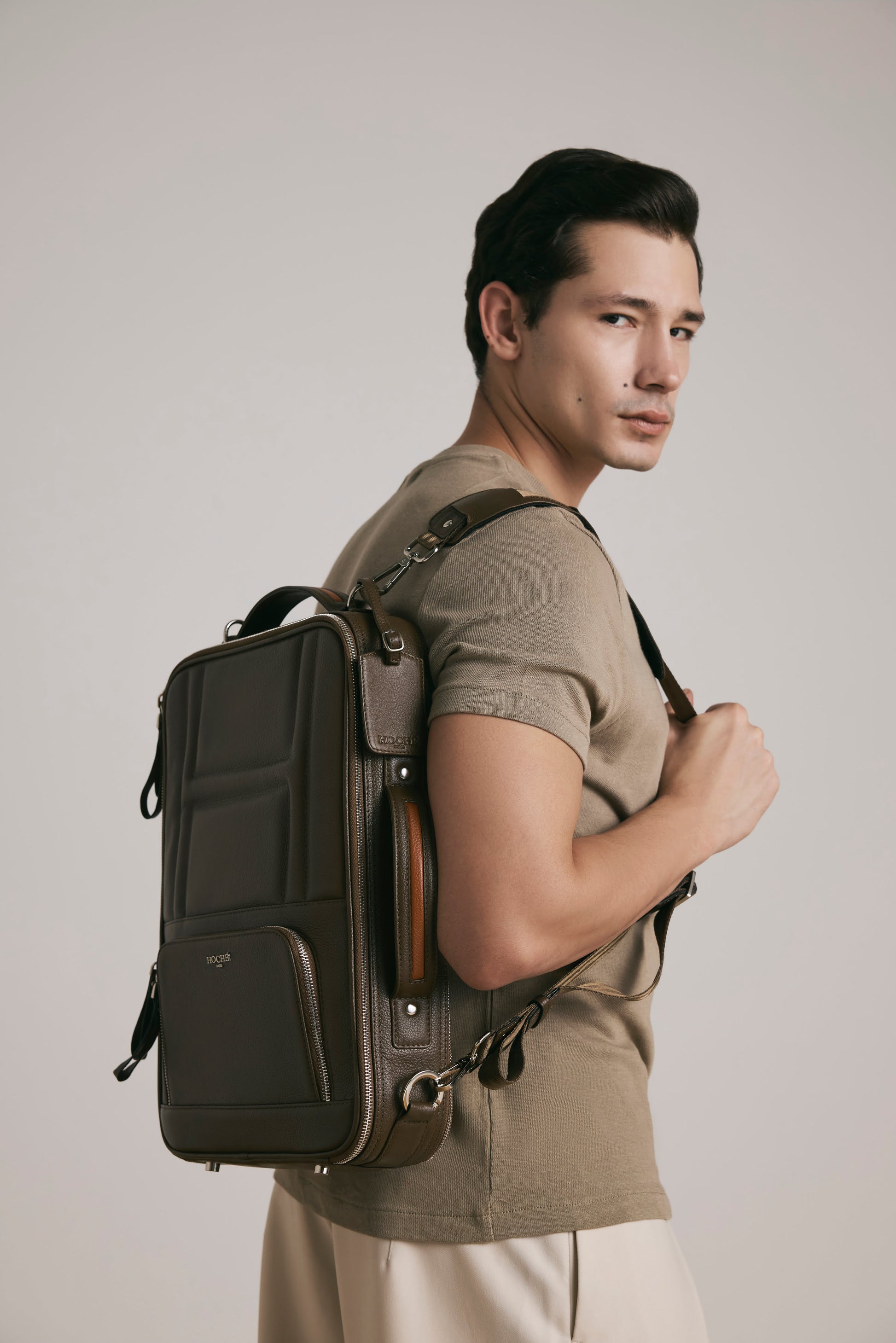 Lifestyle view of UniSwitch dark brown branded genuine leather 3 in 1 convertible  backpack for men in India. Stylish and trendy.