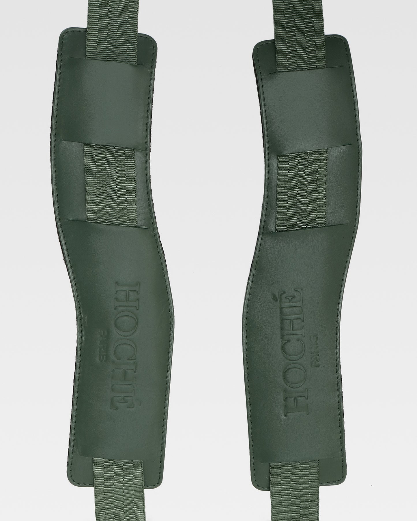 Close-up of UniSwitch olive green genuine leather backpack for men in India, highlighting premium craftsmanship, and Hoche paris embossed logo