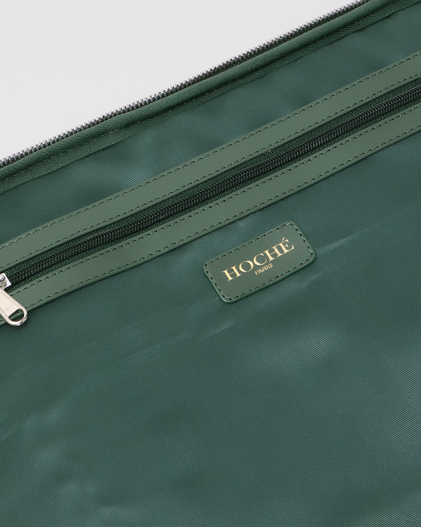 Open closeup view of UniSwitch olive green branded genuine leather backpack for men in India, showcasing spacious compartments, a padded laptop sleeve, and secure storage
