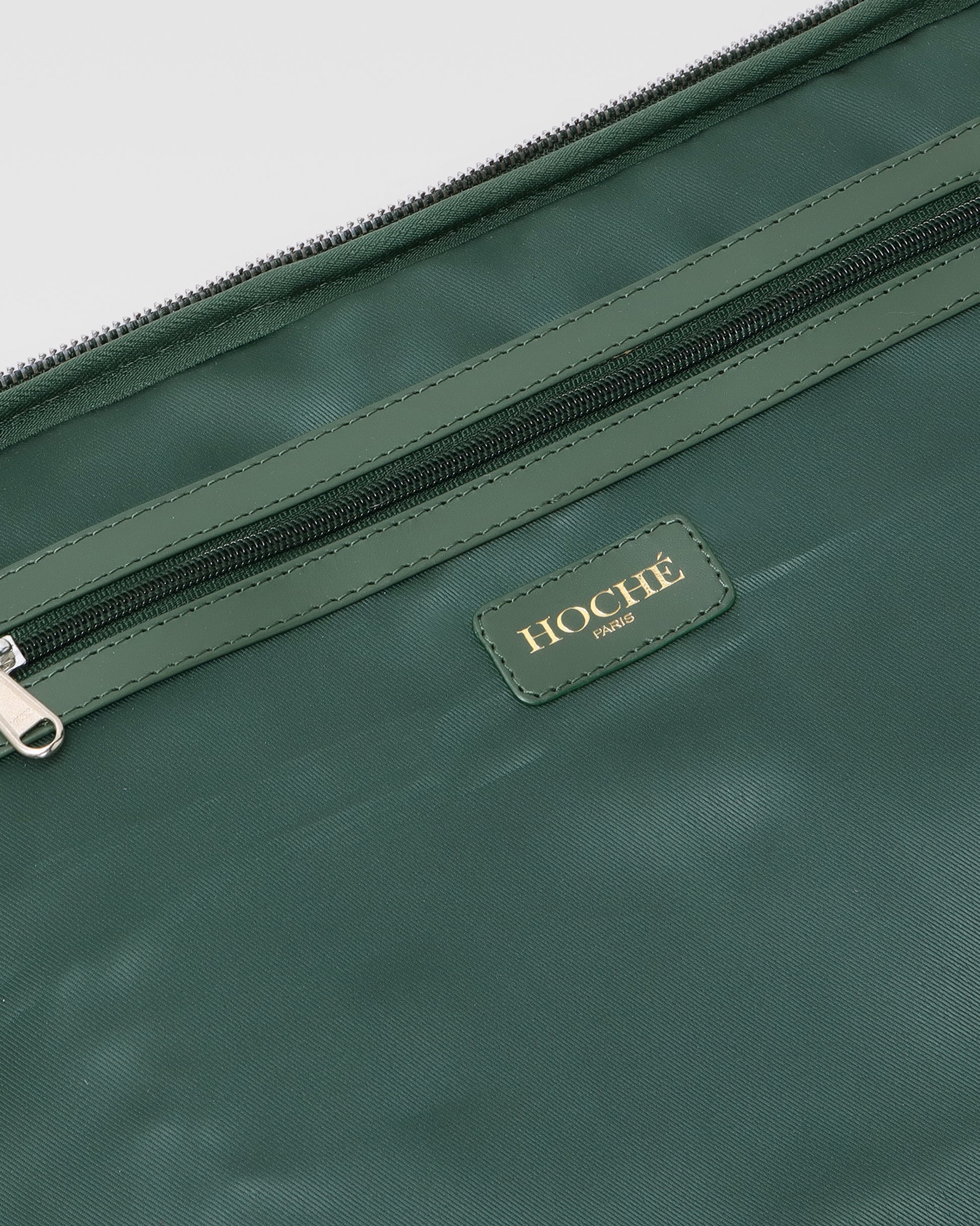 Open closeup view of UniSwitch olive green branded genuine leather backpack for men in India, showcasing spacious compartments, a padded laptop sleeve, and secure storage
