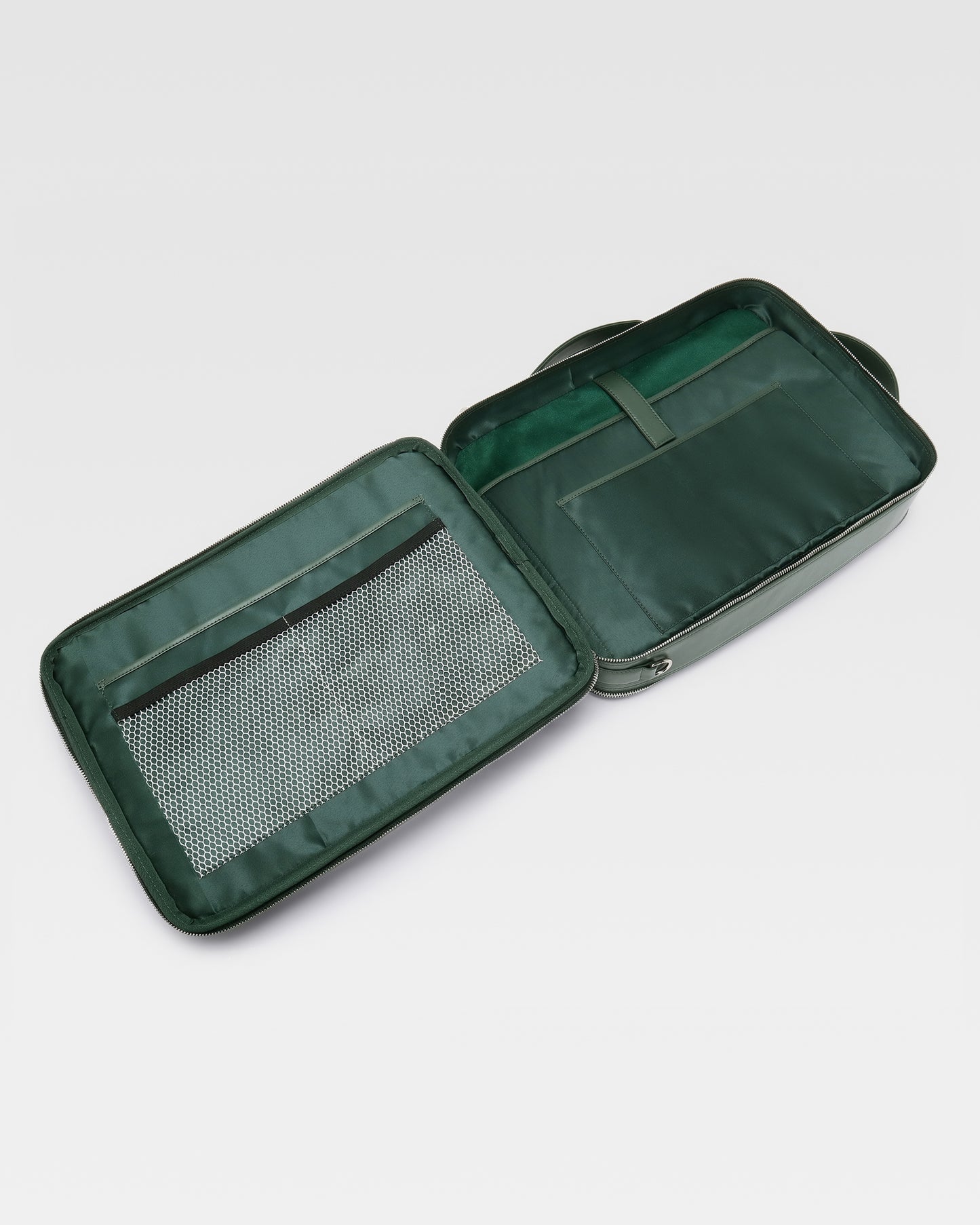 Open view of UniSwitch dark green olive branded genuine leather backpack for men in India, showcasing spacious compartments, a padded laptop sleeve, and secure storage