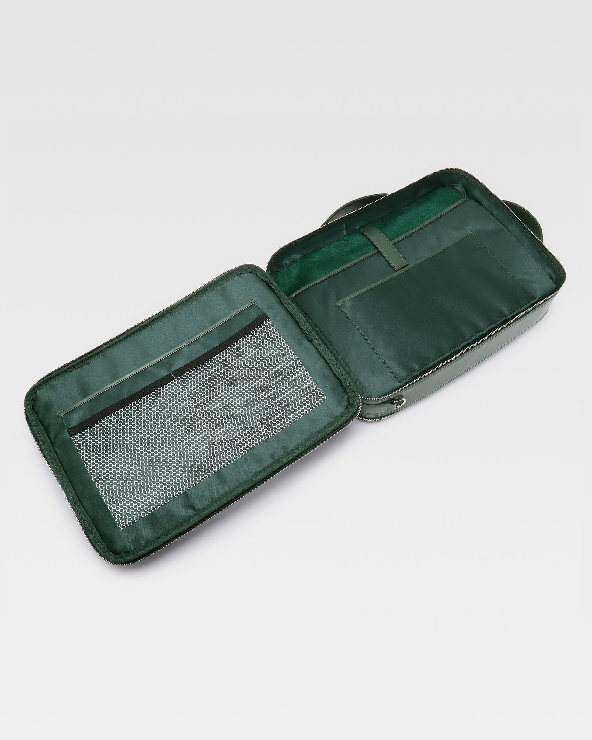 Open view of UniSwitch dark green olive branded genuine leather backpack for men in India, showcasing spacious compartments, a padded laptop sleeve, and secure storage