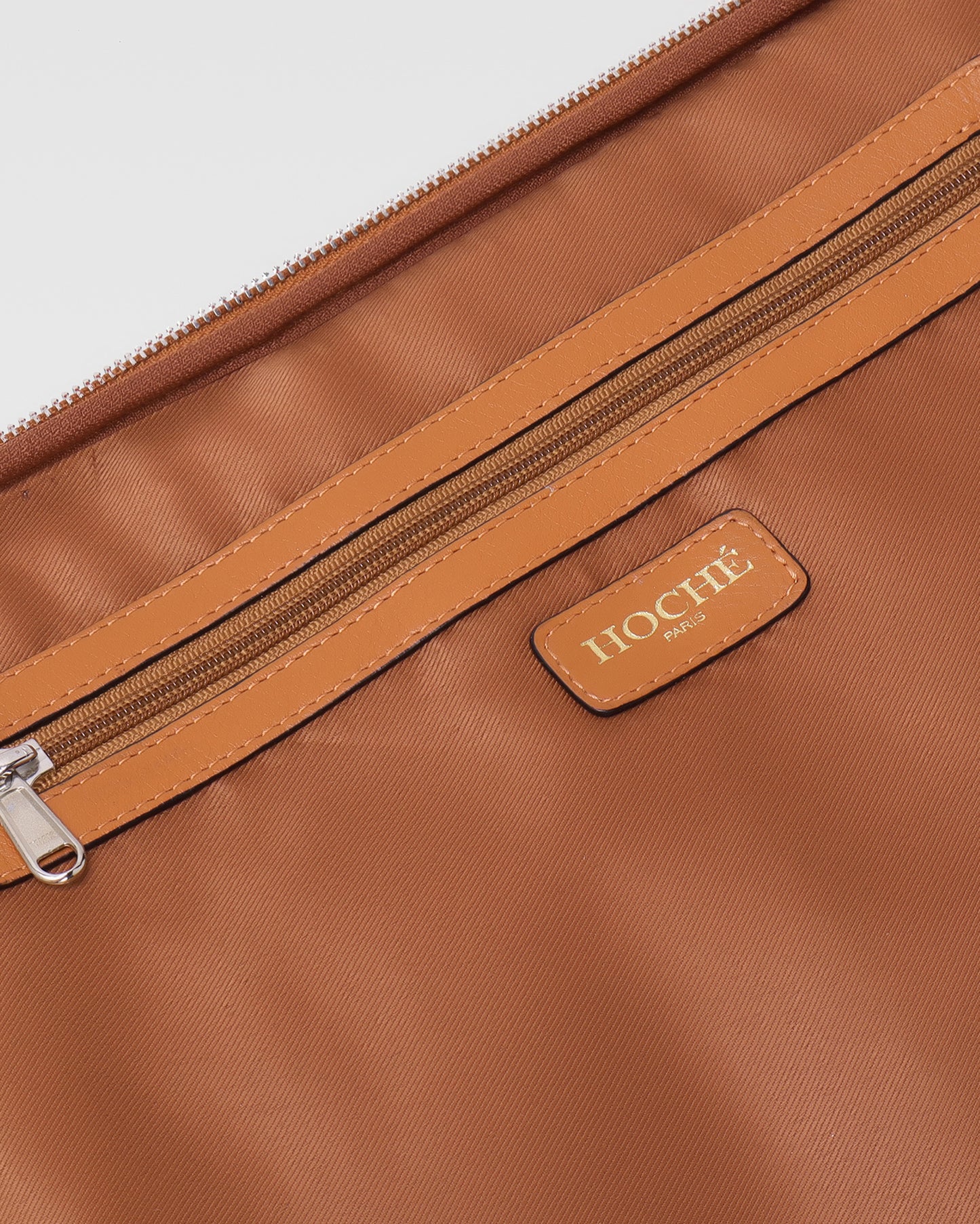 Open closeup view of UniSwitch tan branded genuine leather backpack for men in India, showcasing spacious compartments, a padded laptop sleeve, and secure storage
