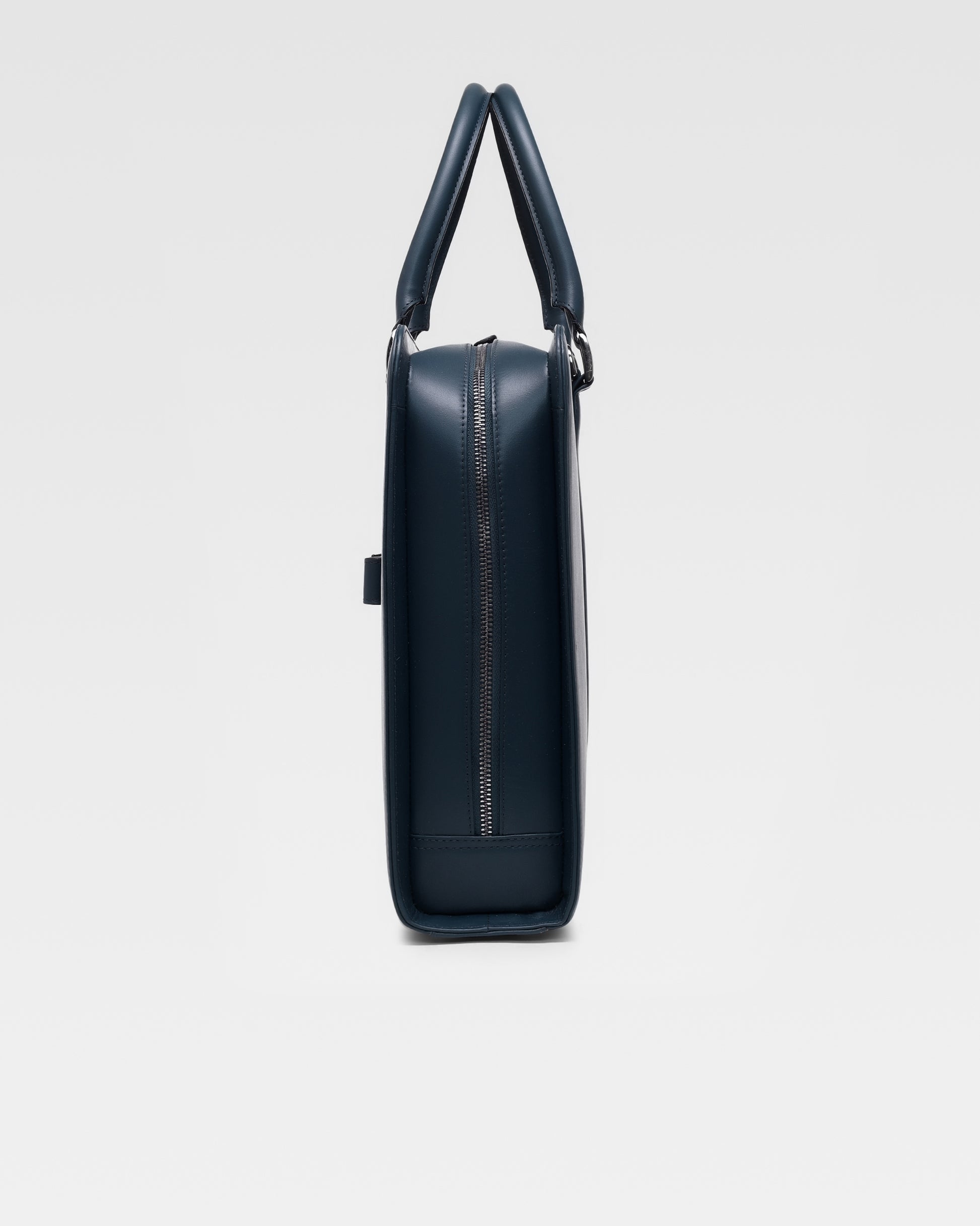 Side profile of PinnaclePro dark blue leather laptop bag for men i India, showcasing its slim, structured design and high-quality craftsmanship