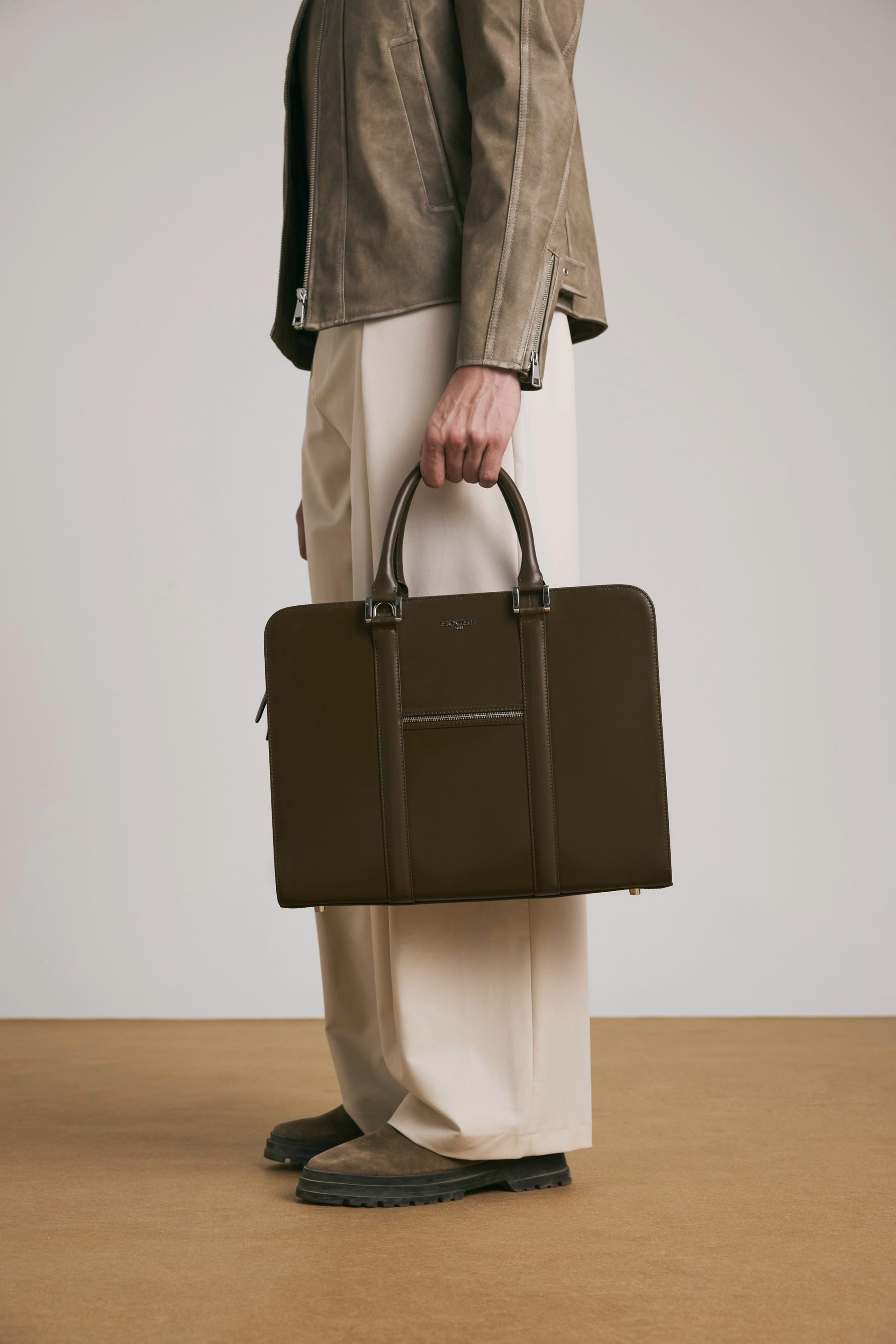 Luxury lifestyle shot of PinnaclePro dark brown branded leather laptop bag for men in Inida, complementing a sophisticated and professional look.