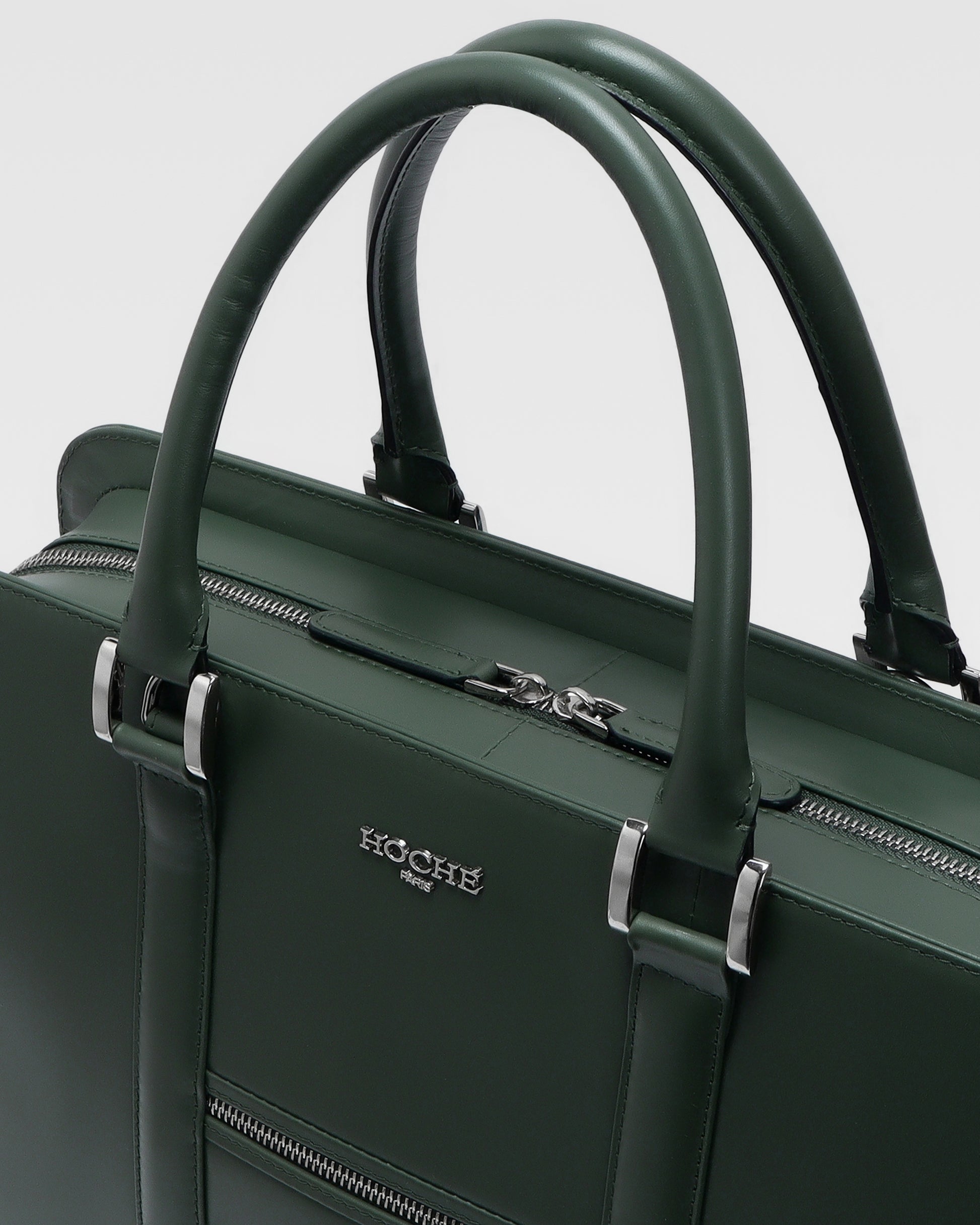 Close-up of PinnaclePro olive green genuine leather laptop bag, highlighting rich leather texture, precision stitching, and custom metal hardware