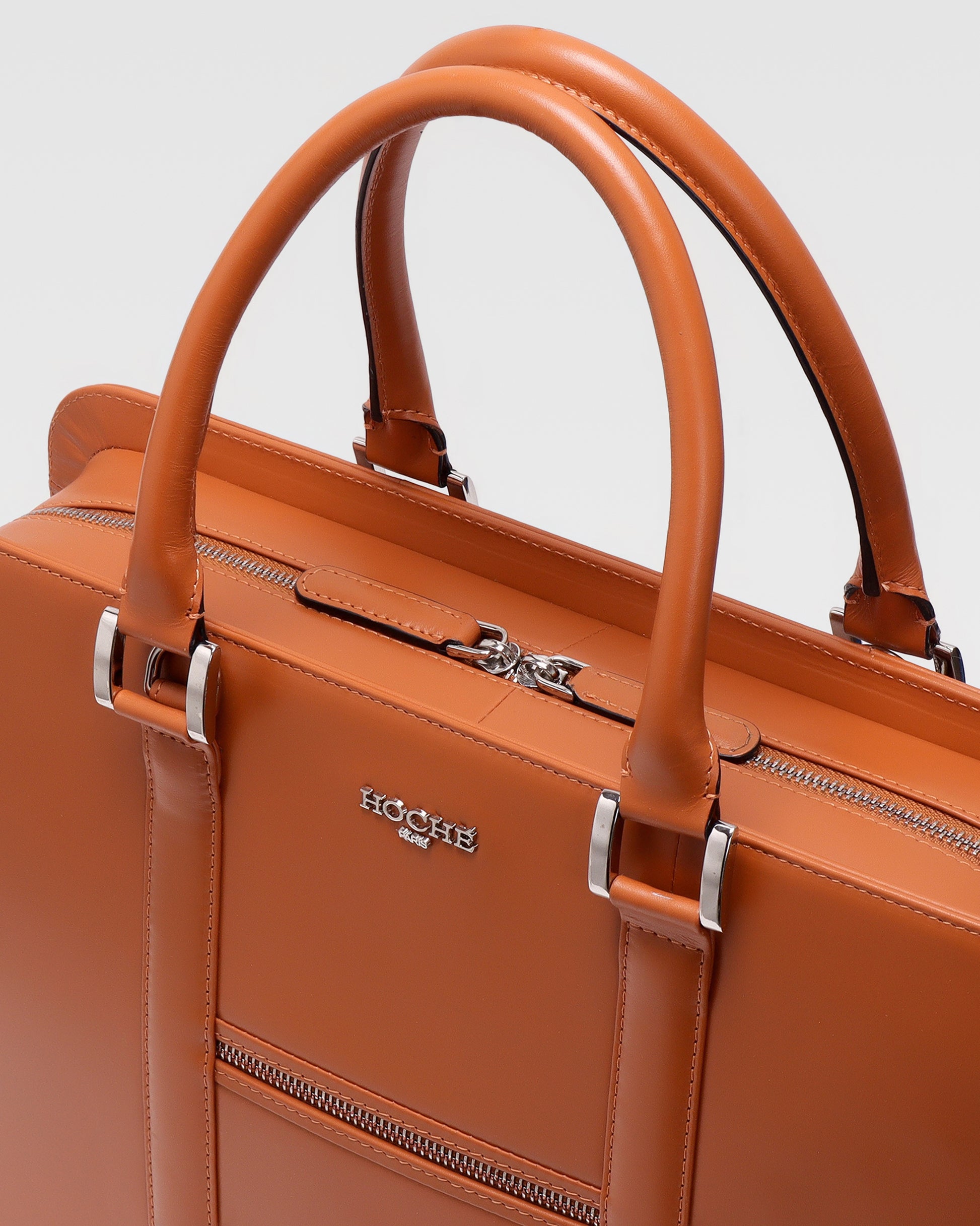 Close-up of PinnaclePro Umber Tan genuine leather laptop bag for men in India, highlighting rich full-grain leather, premium metal hardware, and expert stitching