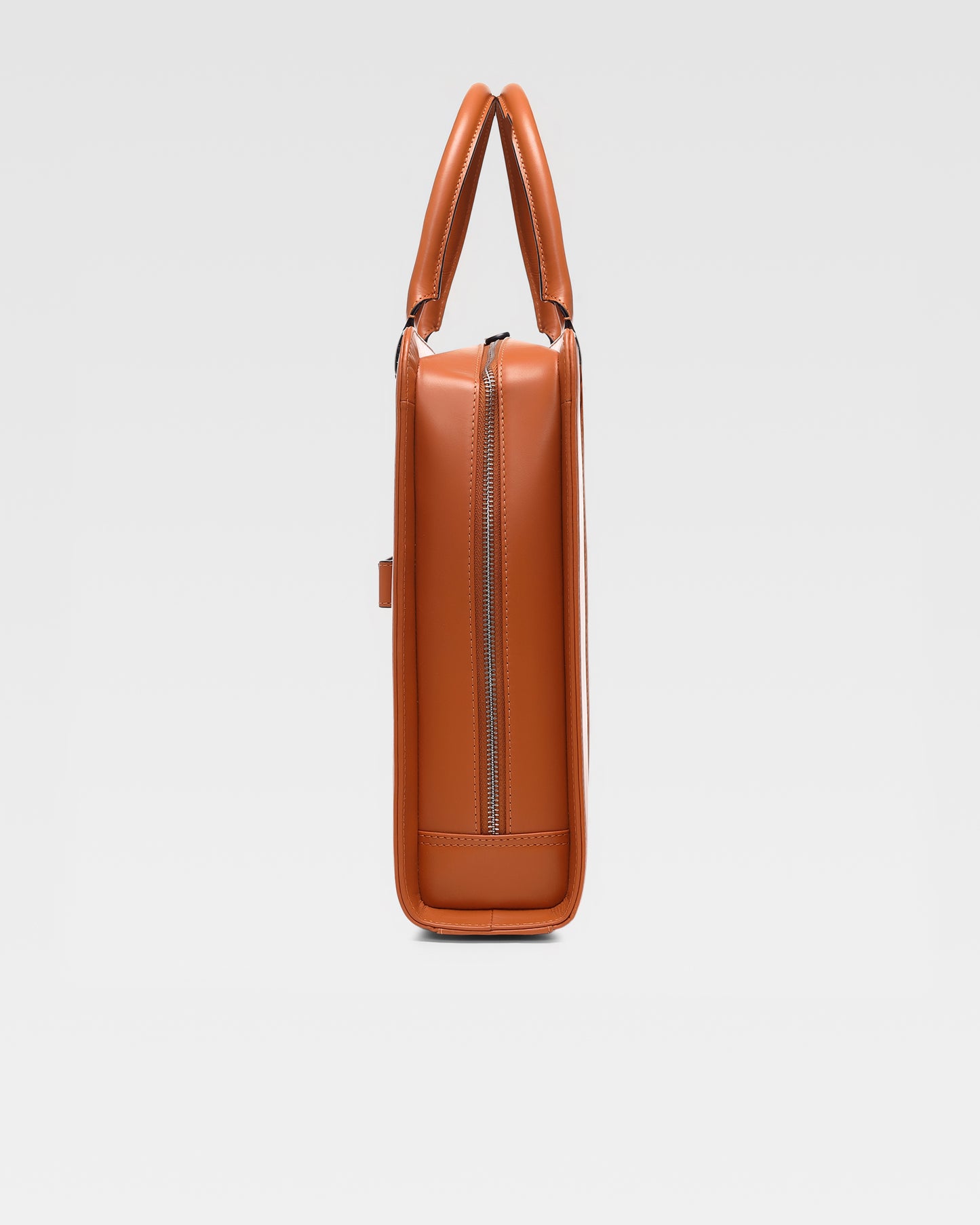 side view of PinnaclePro Umber Tan genuine leather laptop bag for men in India, highlighting rich full-grain leather, premium metal hardware, and expert stitching