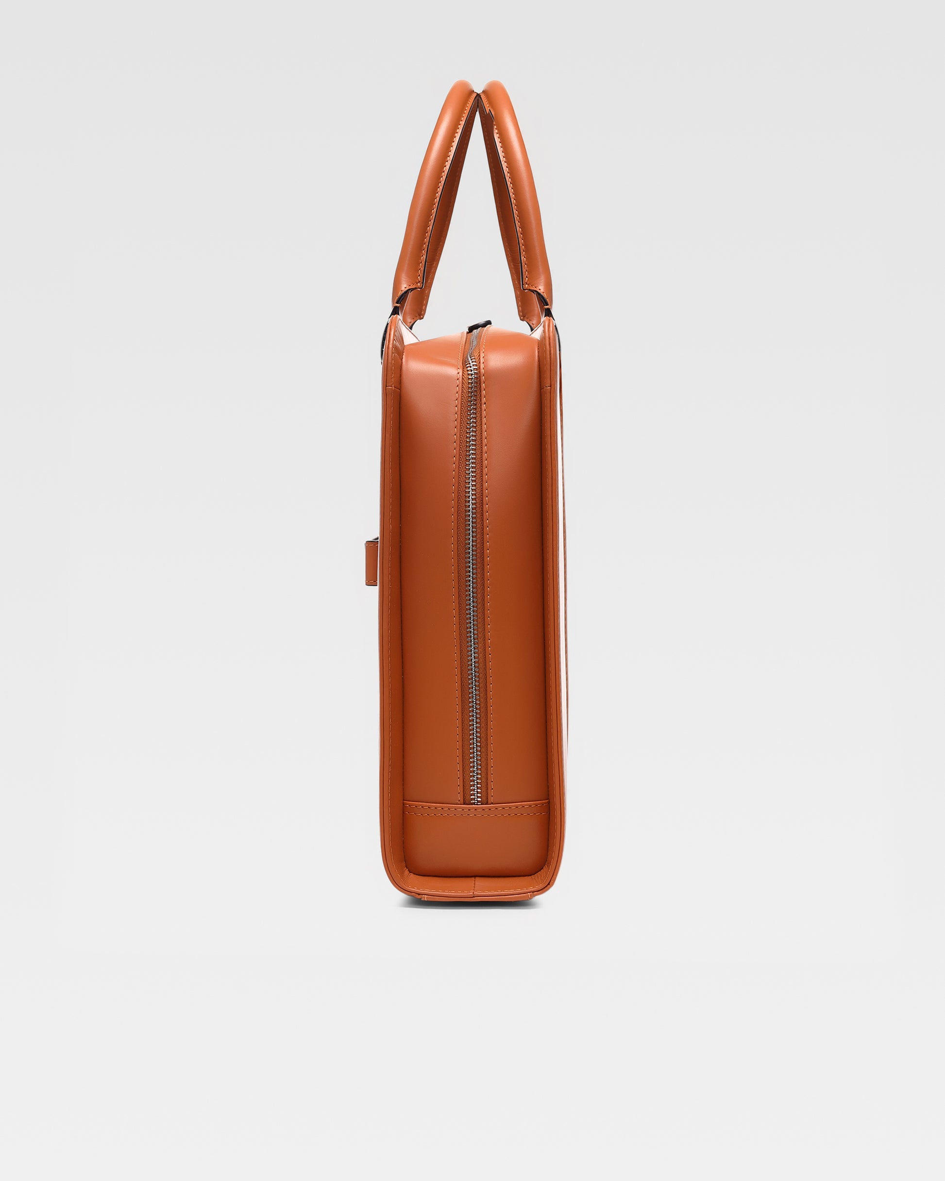 side view of PinnaclePro Umber Tan genuine leather laptop bag for men in India, highlighting rich full-grain leather, premium metal hardware, and expert stitching
