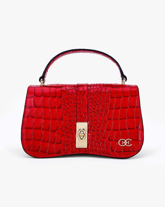 Red handbag with a gold clasp on a white background