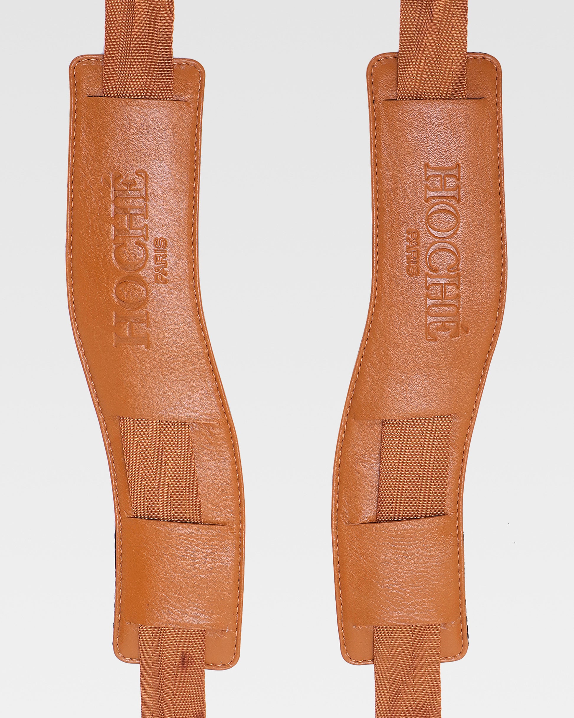 Close-up of UniSwitch tan genuine leather backpack for men in India, highlighting premium craftsmanship, and Hoche paris embossed logo